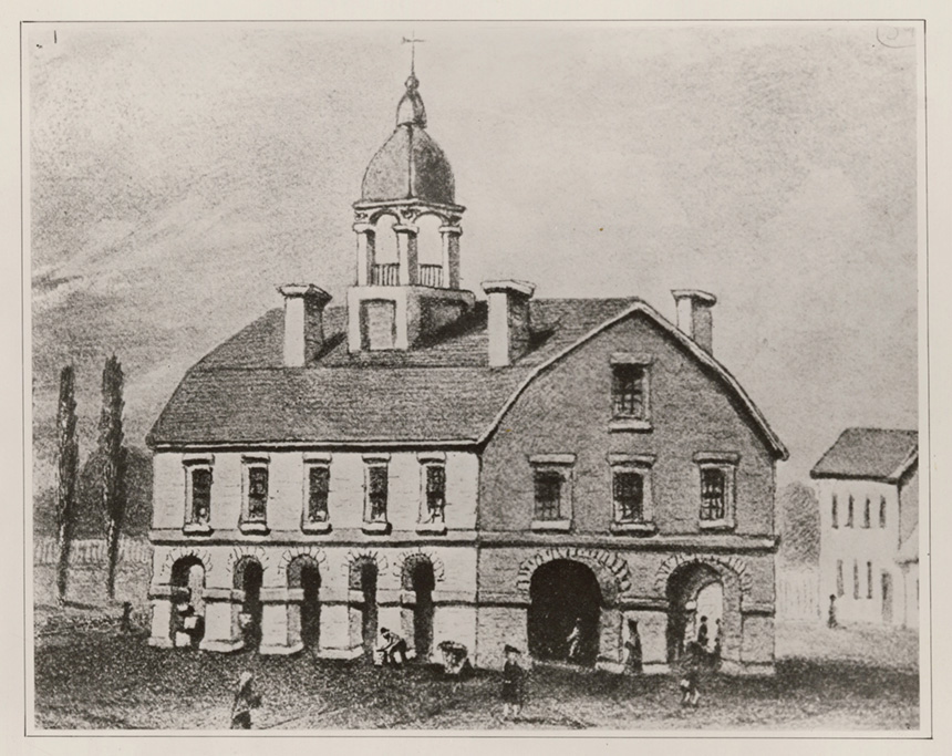 Black and white engraving of a building with arched, open doorways on the ground level and several rectangular 
					windows on the upper floor. A small cupola and three chimney stacks extend from the rooftop. Credit: National Archives.