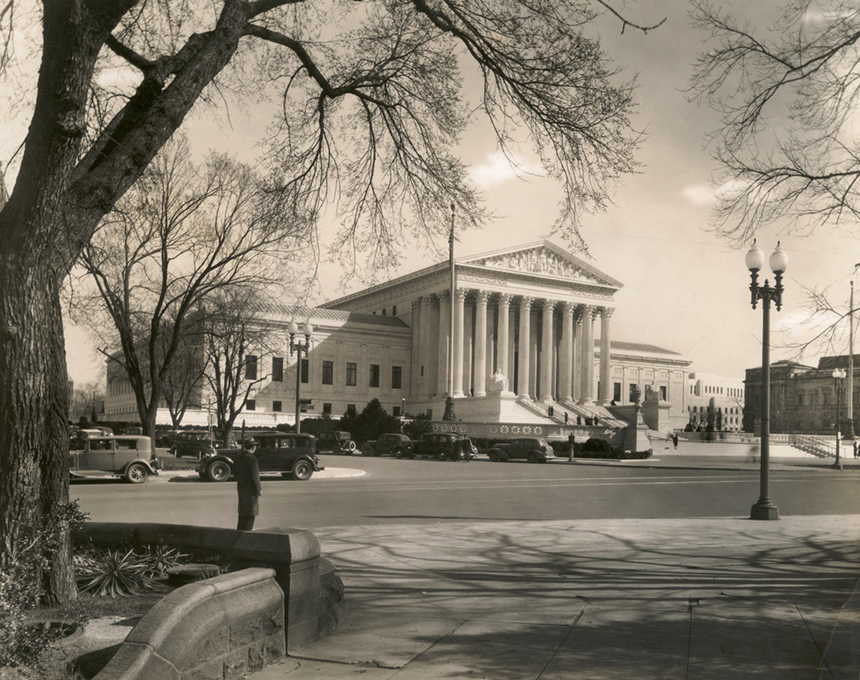 Black and white photograph of the Supreme Court Building taken from across the street. Credit: Handy Studios.