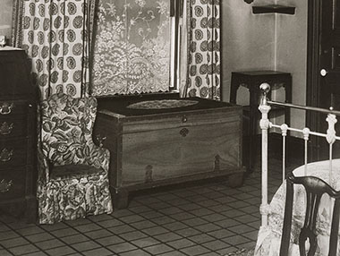 A companion chest in the collection of Harvard Law School is visible under a window of Justice Holmes’s bedroom in his Washington, D.C., home, as seen in this detail from a 1938 photograph.