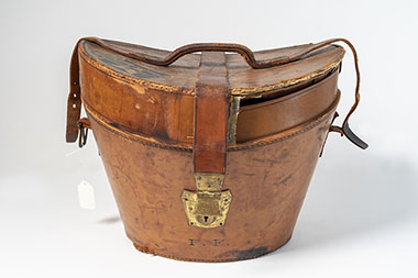 Due to their somewhat cumbersome shape, it was also common for top hats of this era to have their own carrying cases. Justice Frankfurter’s monogrammed leather case features a lockable clasp and handle for easy transport.