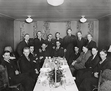 Harry A. Blackmun (the second standing figure from the right) and other members of his law firm at an associate dinner in 1937, held at the King Cole Hotel in Minneapolis, Minnesota.