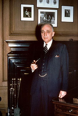 Photograph of Justice John M. Harlan posing in Chambers with the pocket watch chain visible, February 1962.