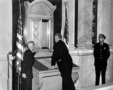 Chief Justice Fred M. Vinson (center) and Alvin Kremer of the Library of Congress (left) view the U.S. Constitution in its new display case at the Library of Congress. Just a year later it was relocated to the National Archives.