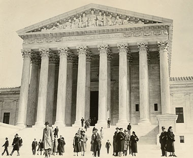 Attorneys and spectators walk across the Supreme Court Building’s West Plaza on October 7, 1935.