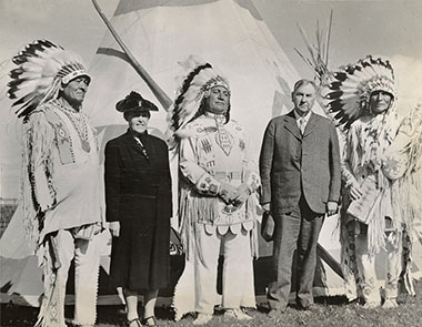 A photograph from after the ceremony included, from left to right, Chief Bull, Eagle Woman (Mrs. Stone), Chief Weasel Feather, Eagle Shield (Justice Stone), and Chief Wades-in-the-water. 