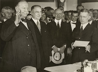 The oaths of office were administered to Taft by Adolph Hoehling, an associate justice of the Supreme Court of the District of Columbia (right, holding the oath). Attorney General Daugherty is standing to Taft’s left.