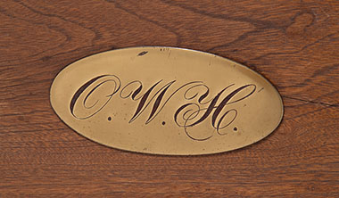 Detail of the brass ownership plate featuring Justice Holmes’s monogram.