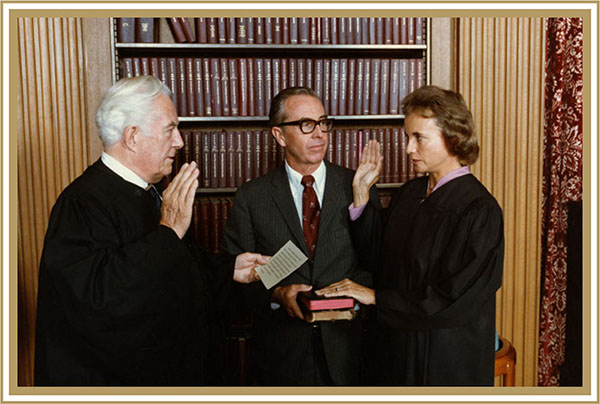Chief Justice Warren E. Burger administers the Judicial Oath to Judge Sandra Day O’Connor while her husband, John J. O’Connor III, holds the family Bibles, 1981.