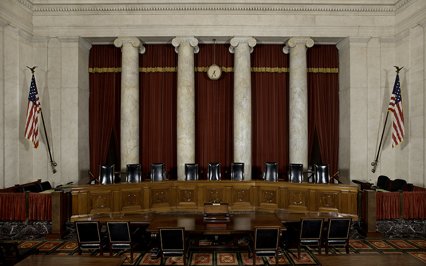 Photo facing justices' bench of empty SCOTUS courtroom. 