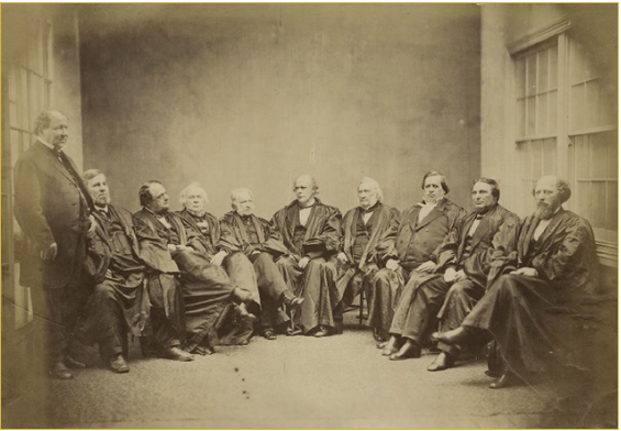 The first group photograph taken of the Justices dressed in the judicial robes also included Clerk of the Court D.W. Middleton (standing at left).